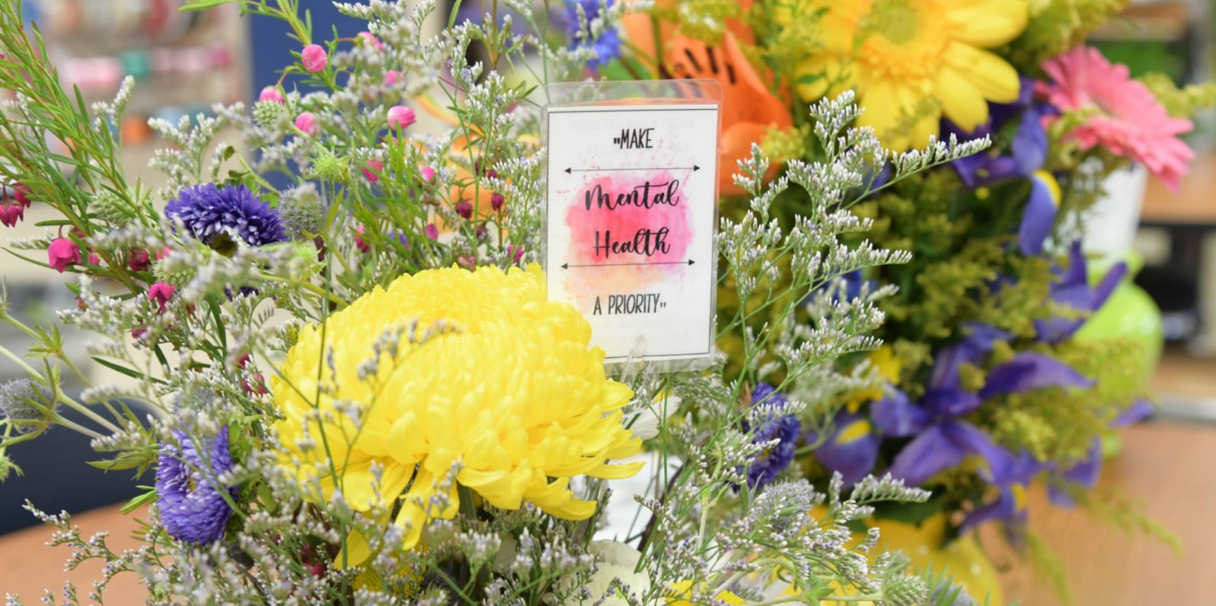 Flowers with the note make mental health a priority