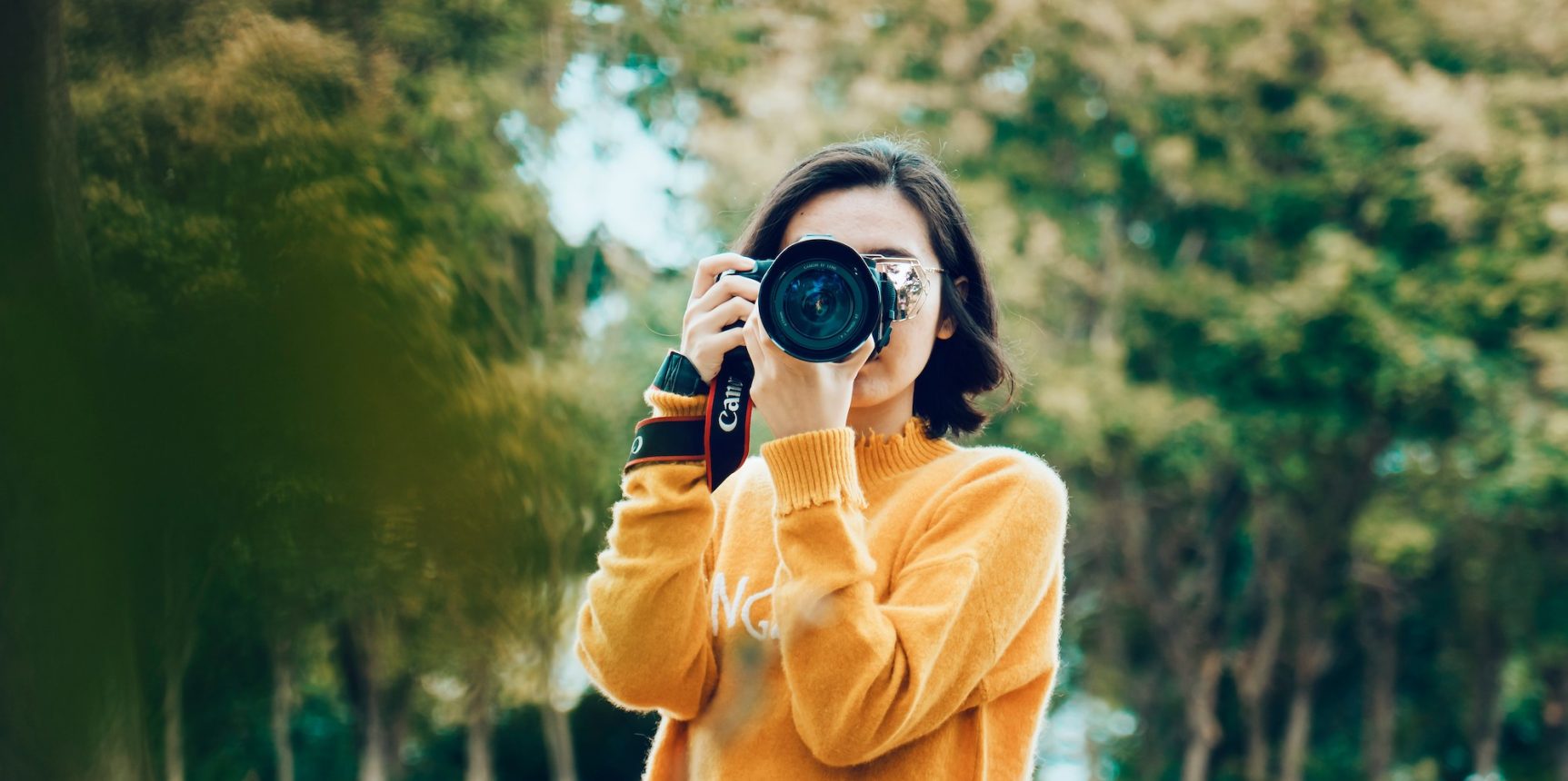 Photo of young girl with a camera in her hands