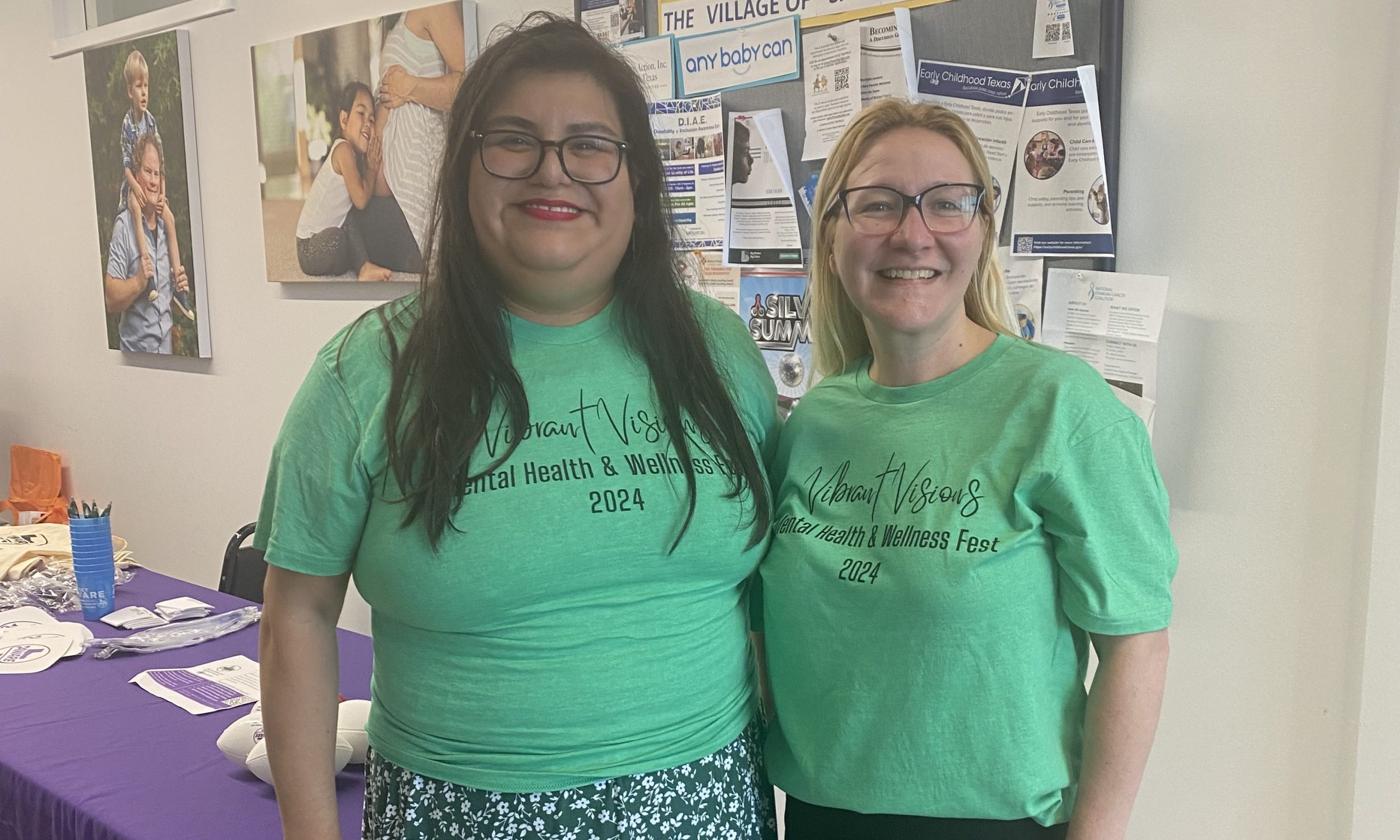 Jenny and Cristal stand next to each other at a local wellness festival